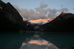 23 First Rays Of Sunrise Burn Clouds And Mount Victoria Yellow Orange Reflected In The Waters Of lake Louise.jpg